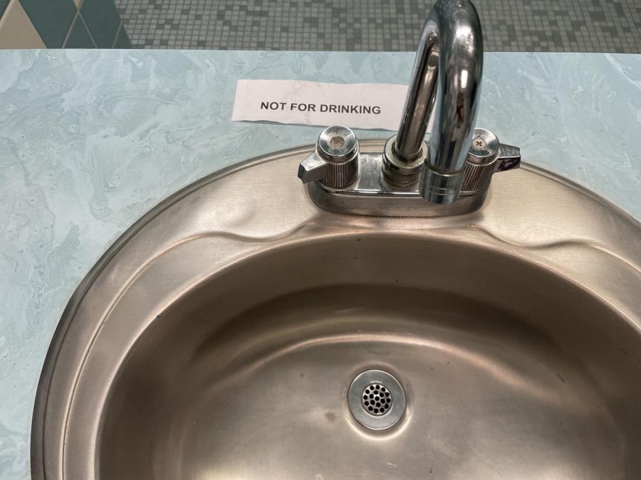 Sign on YHS bathroom sink indicating that there is lead in the water.