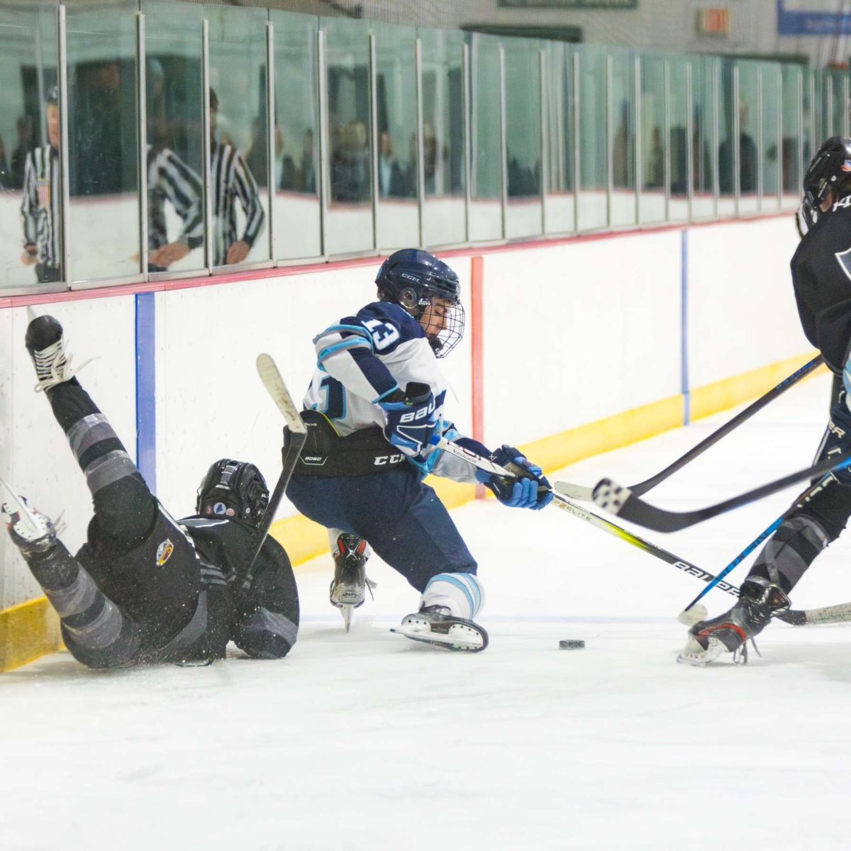 Michael Hanlon (13; Senior) in a competitive  battle for control of the puck.